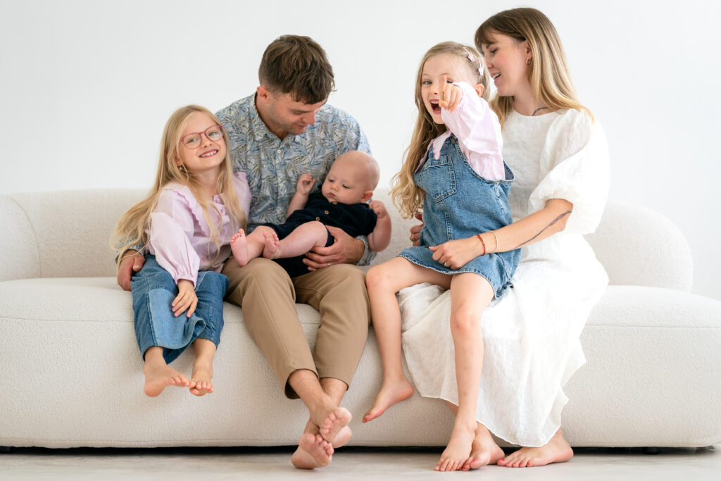 A family sitting together on a couch.