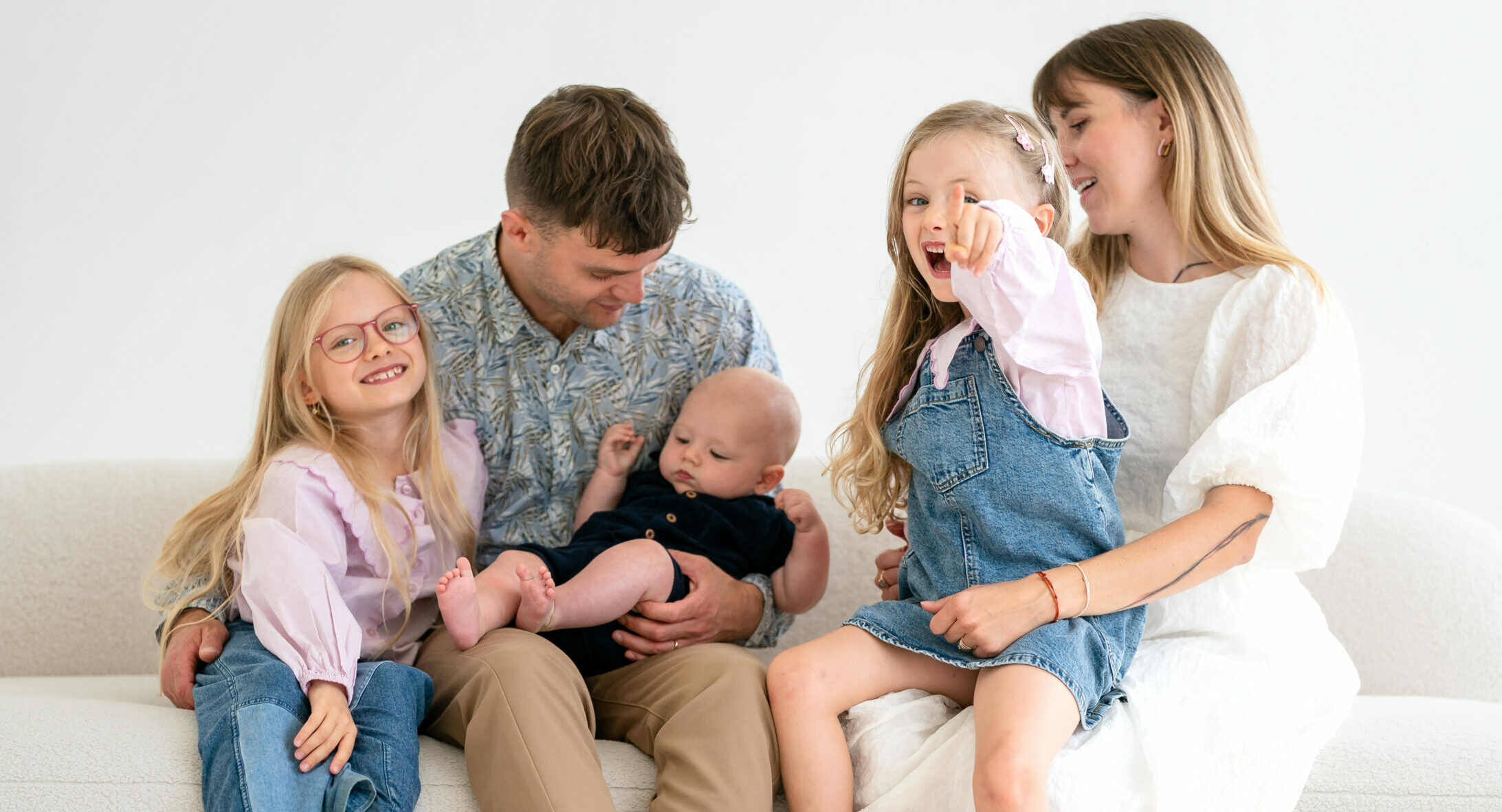 A family sitting together on a couch.